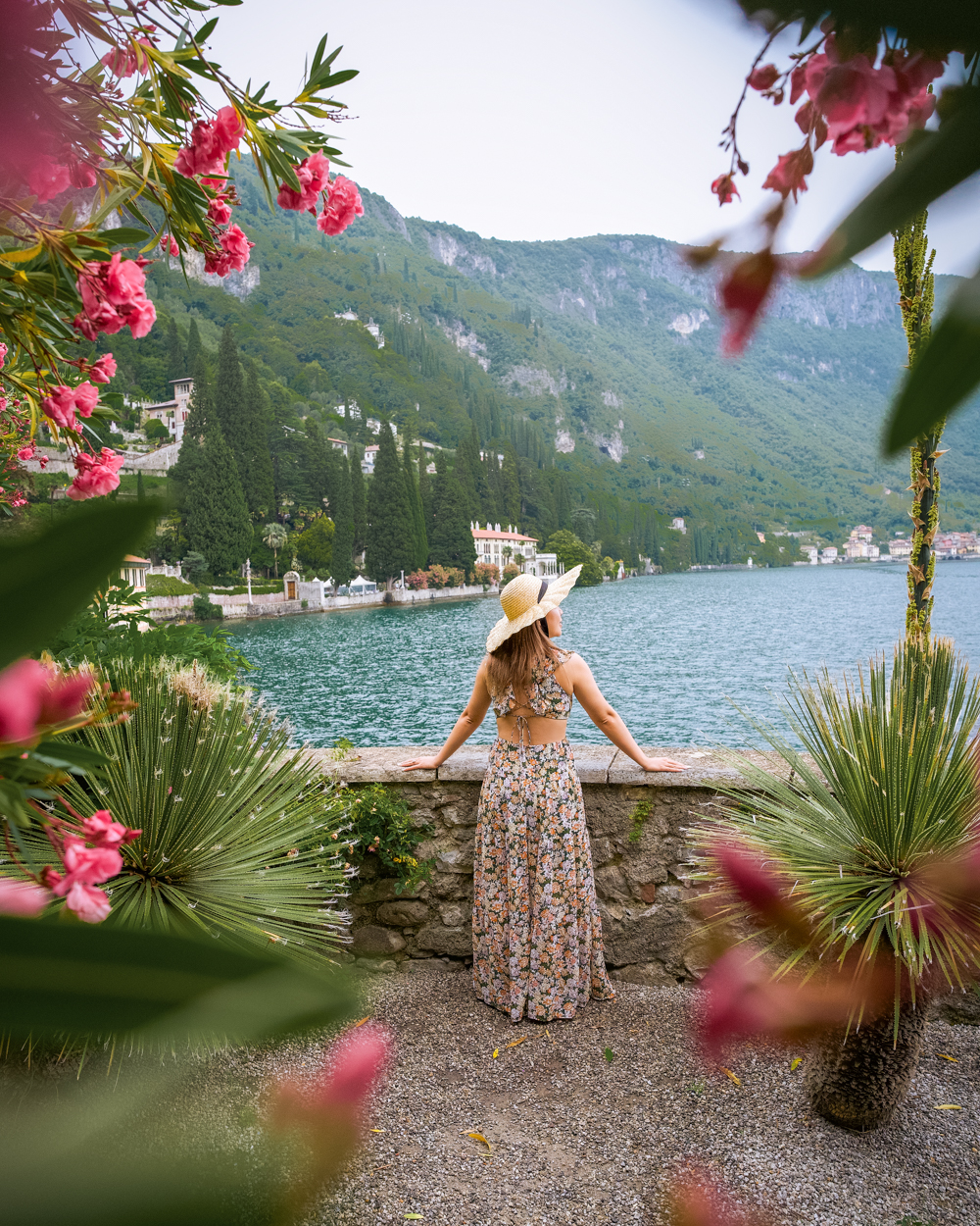 Cindy overlooking Lake Como in Varenna, Italy, framed by pink oleander flowers