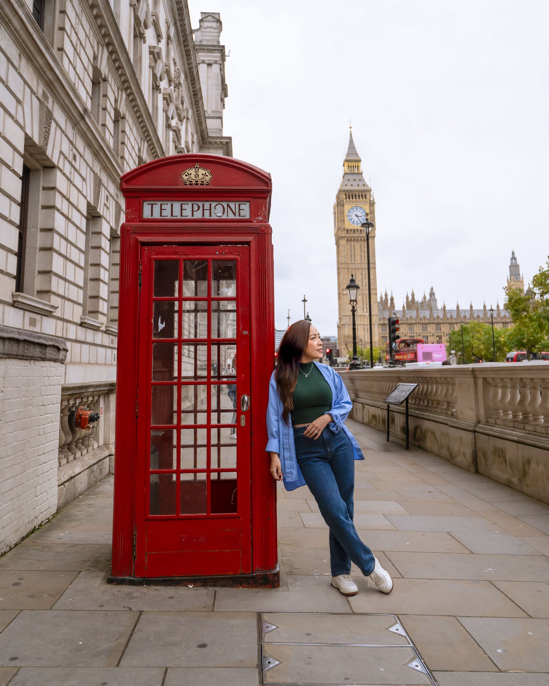 Red telephone booth near Big Ben in London, England
