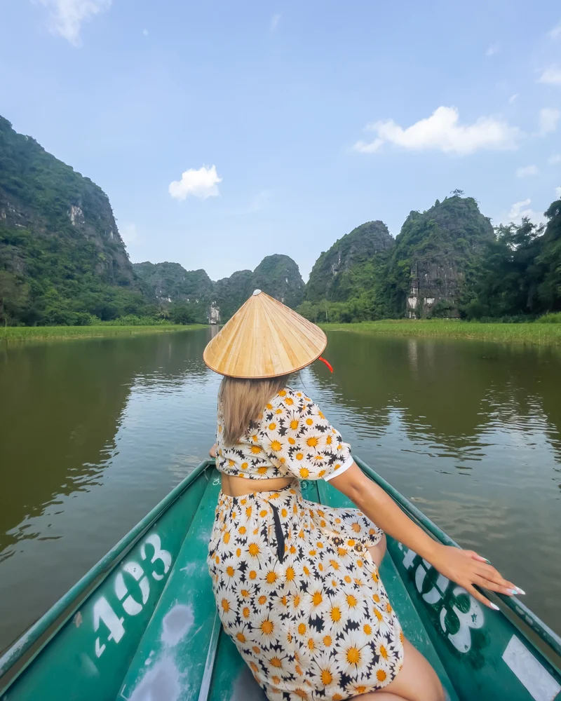 Woman on boat ride in Tam Coc in Ninh Binh, Vietnam.