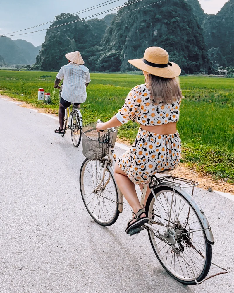 Couple riding bike in Ninh Binh, Vietnam.