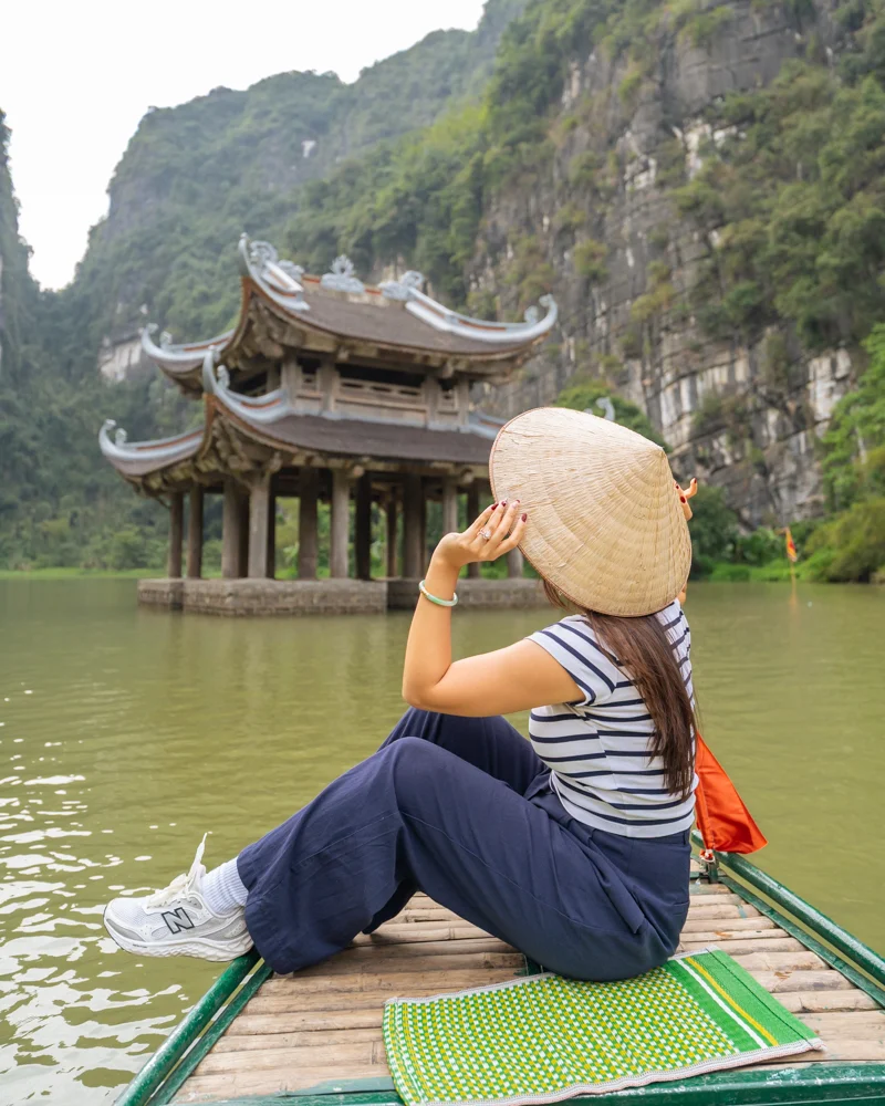 Woman on boat in Trang An in Ninh Binh, Vietnam.