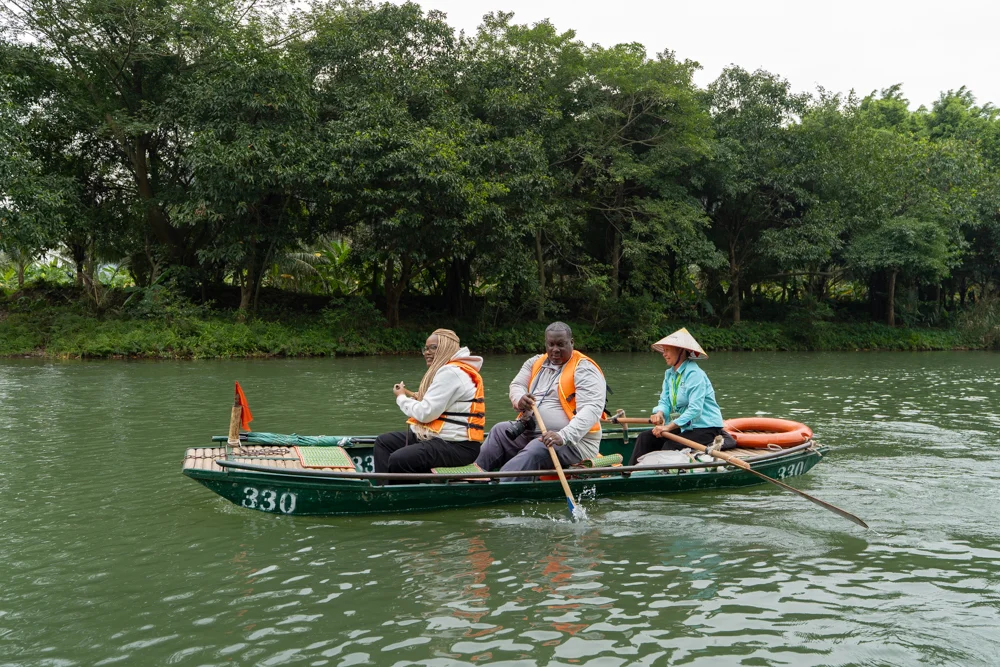 Couple on boat in Trang An in Ninh Binh, Vietnam.