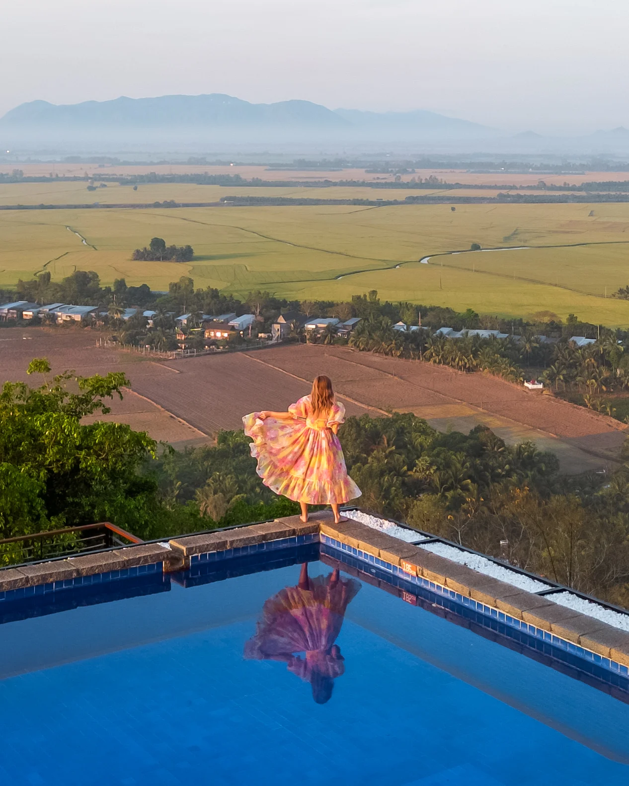 Woman overlooking rice fields in Chau Doc, Vietnam.